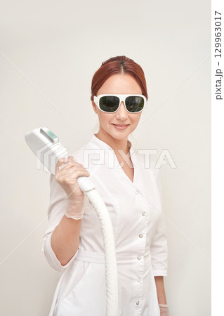Female caucasian adult using laser hair removal equipment in professional spa Female caucasian adult using laser hair removal equipment in professional spa 129963017