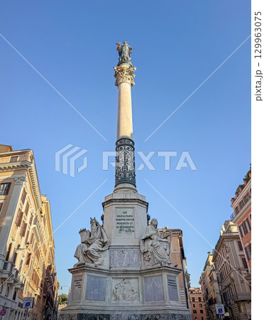 ROME, ITALY - JULY 31, 2025 The Column of the Immaculate Conception. The monument is topped with a bronze statue of the Virgin Mary. The detailed base features marble figures 129963075