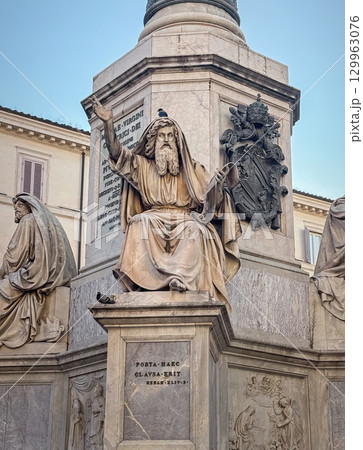 ROME, ITALY - JULY 31, 2025 Close-up of Moses marble statue at the base of the Column of the Immaculate Conception in Roma. The figure of seated prophet with a long beard and flowing robes 129963076