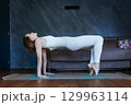 woman in Reverse Table yoga pose at home 129963114
