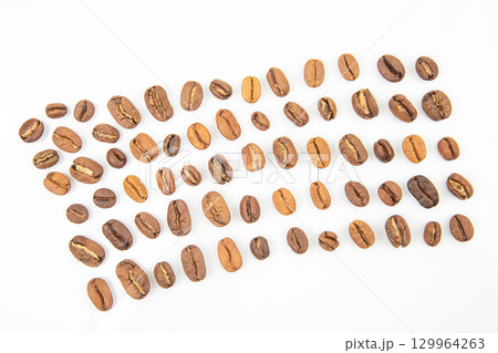 Coffee beans of various types arranged in a unique pattern on a white surface Coffee beans of various types arranged in a unique pattern on a white surface 129964263