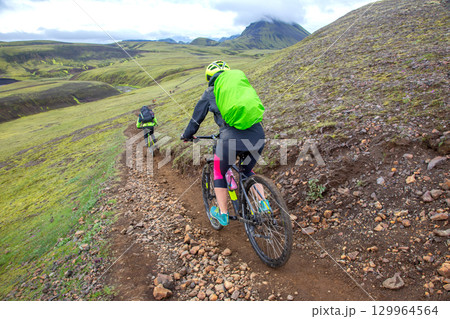 Exploring Iceland rugged trails by mountain bike during a cloudy day Exploring Iceland rugged trails by mountain bike during a cloudy day 129964564