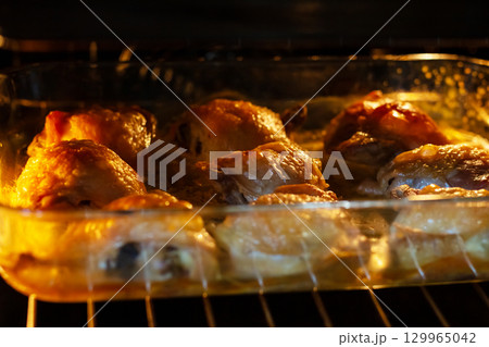 Delicious and Succulent Roasted Chicken Thighs Baking in the Oven Delicious and Succulent Roasted Chicken Thighs Baking in the Oven 129965042