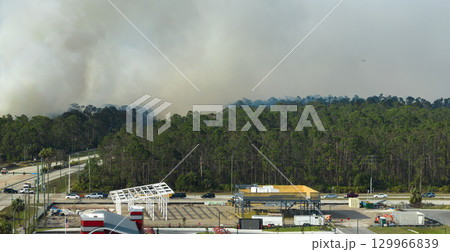 Aerial view of strong wildfire burning severely in North Port city, Florida. Natural disaster during dry season in jungle woods Aerial view of strong wildfire burning severely in North Port city, Florida. Natural disaster during dry season in jungle woods 129966839