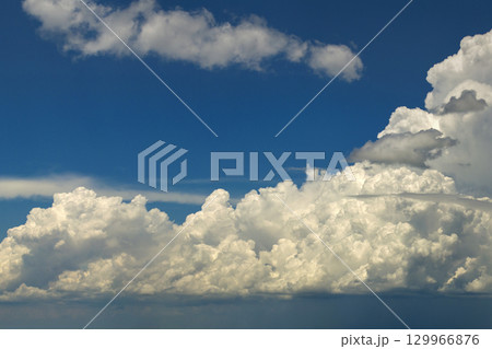 Bright landscape of blue sky with flying white clouds. Colorful summer skyscape Bright landscape of blue sky with flying white clouds. Colorful summer skyscape 129966876