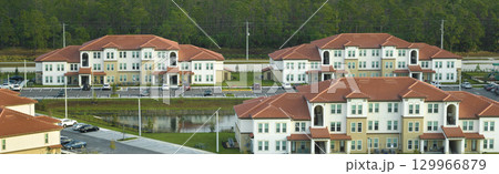 Aerial view of american apartment buildings in Florida residential area. New family condos as example of housing development in US suburbs 129966879