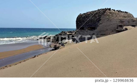 The Coastal Ruins on a Sandy Beach with stunning Azure Waters are a breathtaking sight 129968636