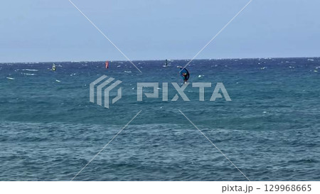 Exciting and Captivating Windsurfing Action Shots Captured on Beautiful, Stunningly Clear Waters Exciting and Captivating Windsurfing Action Shots Captured on Beautiful, Stunningly Clear Waters 129968665
