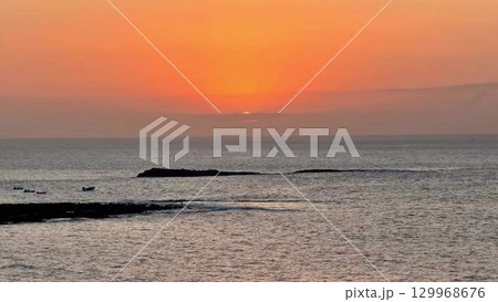 Experience a Stunning Sunset Over the Tranquil Ocean Waters on a Peaceful Evening Experience a Stunning Sunset Over the Tranquil Ocean Waters on a Peaceful Evening 129968676