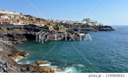 Experience the scenic and breathtaking view of the vibrant Tenerife shoreline by the ocean 129968682
