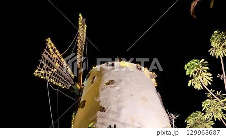 The Stunningly Illuminated Windmill at Night in a Beautiful Tropical Paradise Setting The Stunningly Illuminated Windmill at Night in a Beautiful Tropical Paradise Setting 129968687