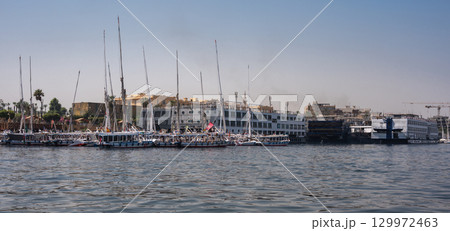 Traditional Egyptian Felucca Boats Docked on the Nile River Traditional Egyptian Felucca Boats Docked on the Nile River 129972463