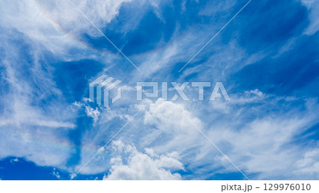 二重のハロ現象と、二層になって流れるたくさんの白い雲 129976010