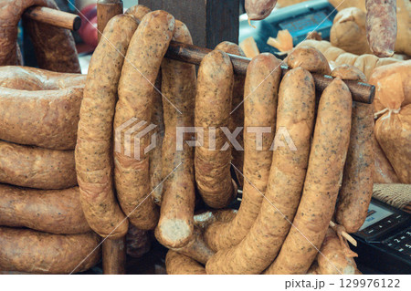Fresh prepared smoked sausages with spices on market stall Fresh prepared smoked sausages with spices on market stall 129976122