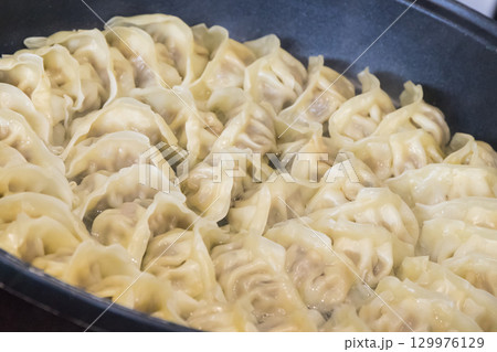 Fried dumplings on frying pan. Traditional food Fried dumplings on frying pan. Traditional food 129976129