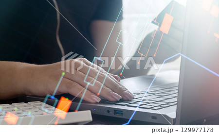 Woman trading stocks online using laptop Woman trading stocks online using laptop 129977178