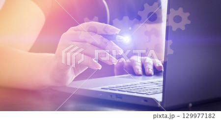 Woman configuring digital system on laptop Woman configuring digital system on laptop 129977182