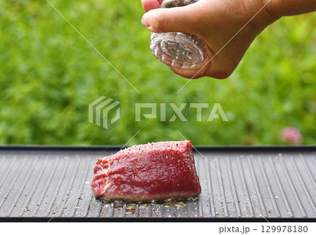cook preparing fresh raw beef fillet mignon steak 129978180