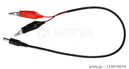 Insulated wire with crocodile clips at the ends and a connector, on a white background in insulation 129979079