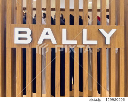 Bally brand display featuring wooden slats and stylish clothing in a modern retail environment 129980906