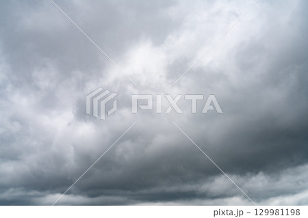 Dramatic overcast sky with gray and white clouds before rainy season storm, moody and gloomy weather background. Climate, meteorology, and atmospheric. Weather forecasting, climate change background. Dramatic overcast sky with gray and white clouds before rainy season storm, moody and gloomy weather background. Climate, meteorology, and atmospheric. Weather forecasting, climate change background. 129981198