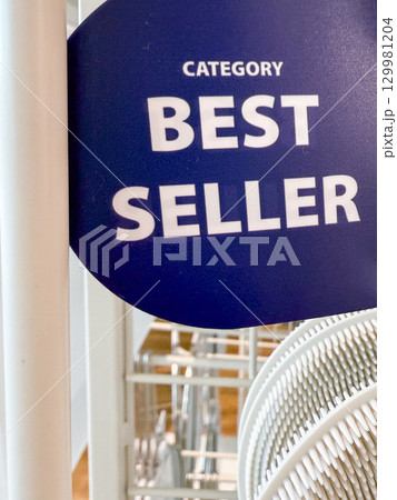 Best seller sign displayed prominently in a retail store showcasing popular products for customers 129981204