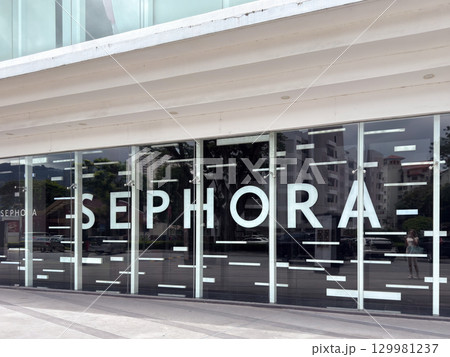 Modern storefront design in Penang highlighting large glass entrance and branding 129981237