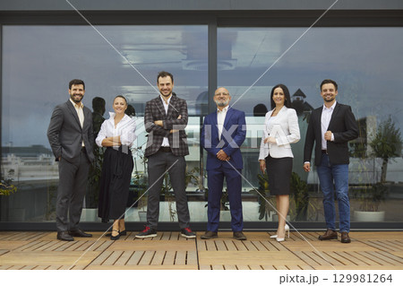 Confident business people team of professionals on rooftop office terrace 129981264