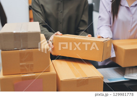 Portrait of Starting small businesses SME owners, two Asian woman check online orders Selling products working with boxs freelance work at home office, sme business online small medium enterprise 129981778