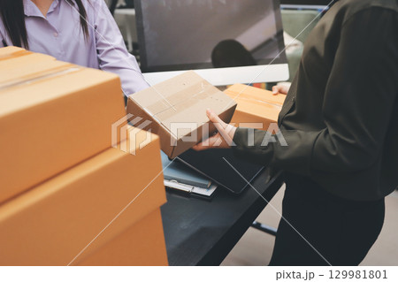 Portrait of Starting small businesses SME owners, two Asian woman check online orders Selling products working with boxs freelance work at home office, sme business online small medium enterprise 129981801