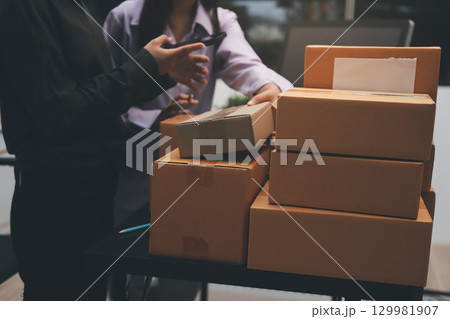 Portrait of Starting small businesses SME owners, two Asian woman check online orders Selling products working with boxs freelance work at home office, sme business online small medium enterprise 129981907