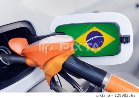 The Brazilian flag on the lid of the gas tank of a car at a gas station in close-up. High or low gasoline prices at Brazilian gas stations. In Brazil, gasoline prices are rising due to a shortage of The Brazilian flag on the lid of the gas tank of a car at a gas station in close-up. High or low gasoline prices at Brazilian gas stations. In Brazil, gasoline prices are rising due to a shortage of 129982368