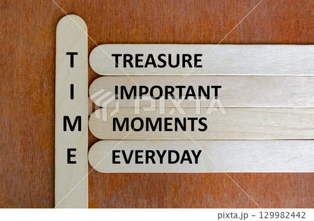 Wooden stick acronym TIME reminding people to value moments, practice mindfulness, and cherish meaningful life experiences daily 129982442