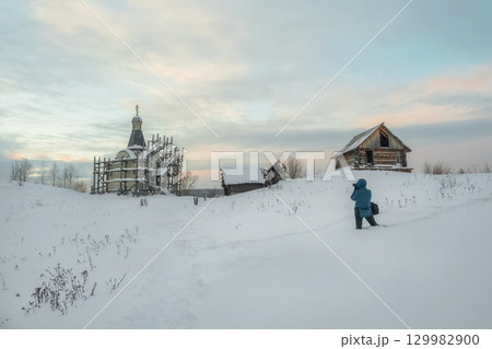 Old church in scaffolding. In winter 129982900