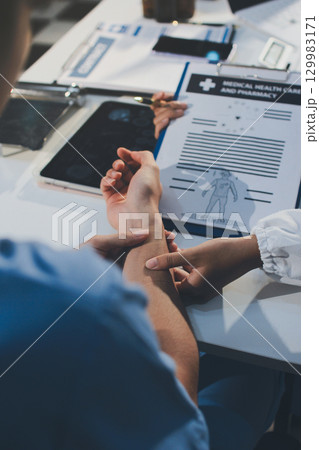 Young brunette woman having consultation at doctor office during 129983171