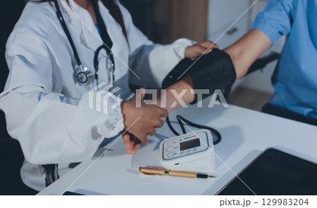 Doctor checking patient arterial blood pressure in hospital. Health care Concept Doctor checking patient arterial blood pressure in hospital. Health care Concept 129983204