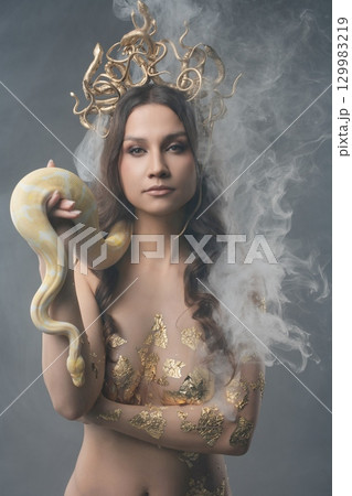 Beauty and strength unite in a captivating artistic display with a snake 129983219
