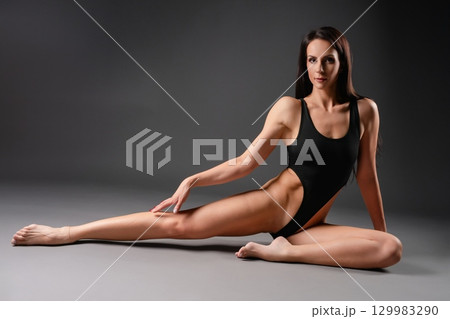 Fitness enthusiast showcasing flexibility in sporty lingerie during practice Fitness enthusiast showcasing flexibility in sporty lingerie during practice 129983290