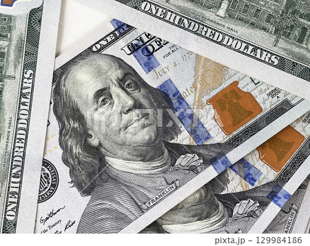 Close up of US dollar paper bills on white table, finance and banking concept, salary, income, financial literacy, personal economy, investment and cash savings background Close up of US dollar paper bills on white table, finance and banking concept, salary, income, financial literacy, personal economy, investment and cash savings background 129984186