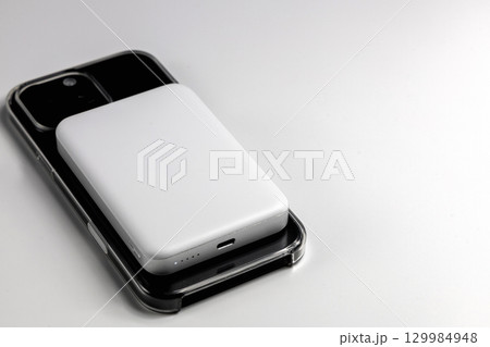 Closeup iPhone charging using magnetic powerbank device Closeup iPhone charging using magnetic powerbank device 129984948