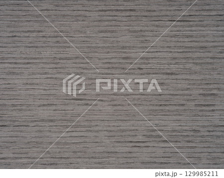 Steady grey tones ripple across the consistent grain of oak veneer Steady grey tones ripple across the consistent grain of oak veneer 129985211