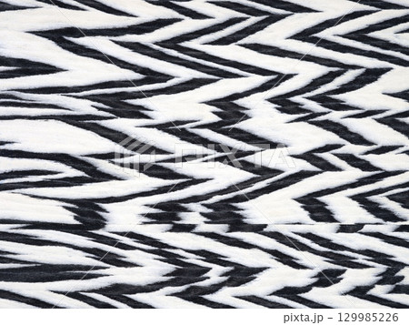 Monochromatic zebra pattern on a textured veneer surface with striking contrast 129985226