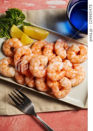 Peeled shrimp on a plate, seafood, shrimp, protein food Peeled shrimp on a plate, seafood, shrimp, protein food 129985478