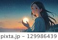 夜明け前の静かな街の中、女性の手には小さな光の粒が握られている。希望のイメージ。 129986439