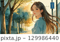 朝焼けの静かな街角に立つ若い女性。前向きなイメージ。 129986440