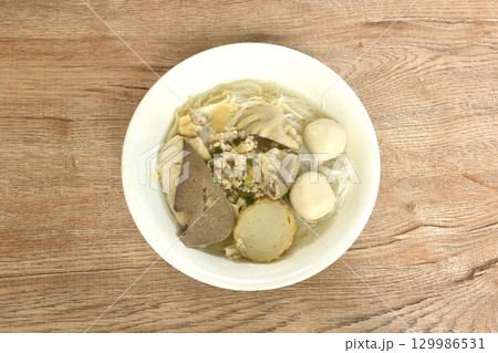 boiled vermicelli thin rice noodles topping pork ball and entrails with chop pork in clear soup on bowl  129986531