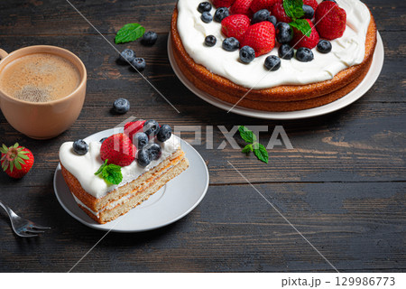 Sponge cake with whipped cream and fresh berries Sponge cake with whipped cream and fresh berries 129986773