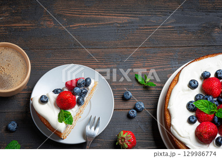 Sponge cake with whipped cream and fresh berries Sponge cake with whipped cream and fresh berries 129986774