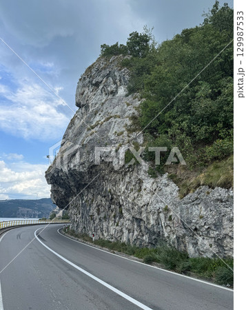View of the highway and cliffs. The Golubac Castle was a medieval fortified town on the Danube River in Serbia 129987533