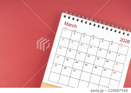 March 2026 desk calendar on red color background. Flat lay. March 2026 desk calendar on red color background. Flat lay. 129987548